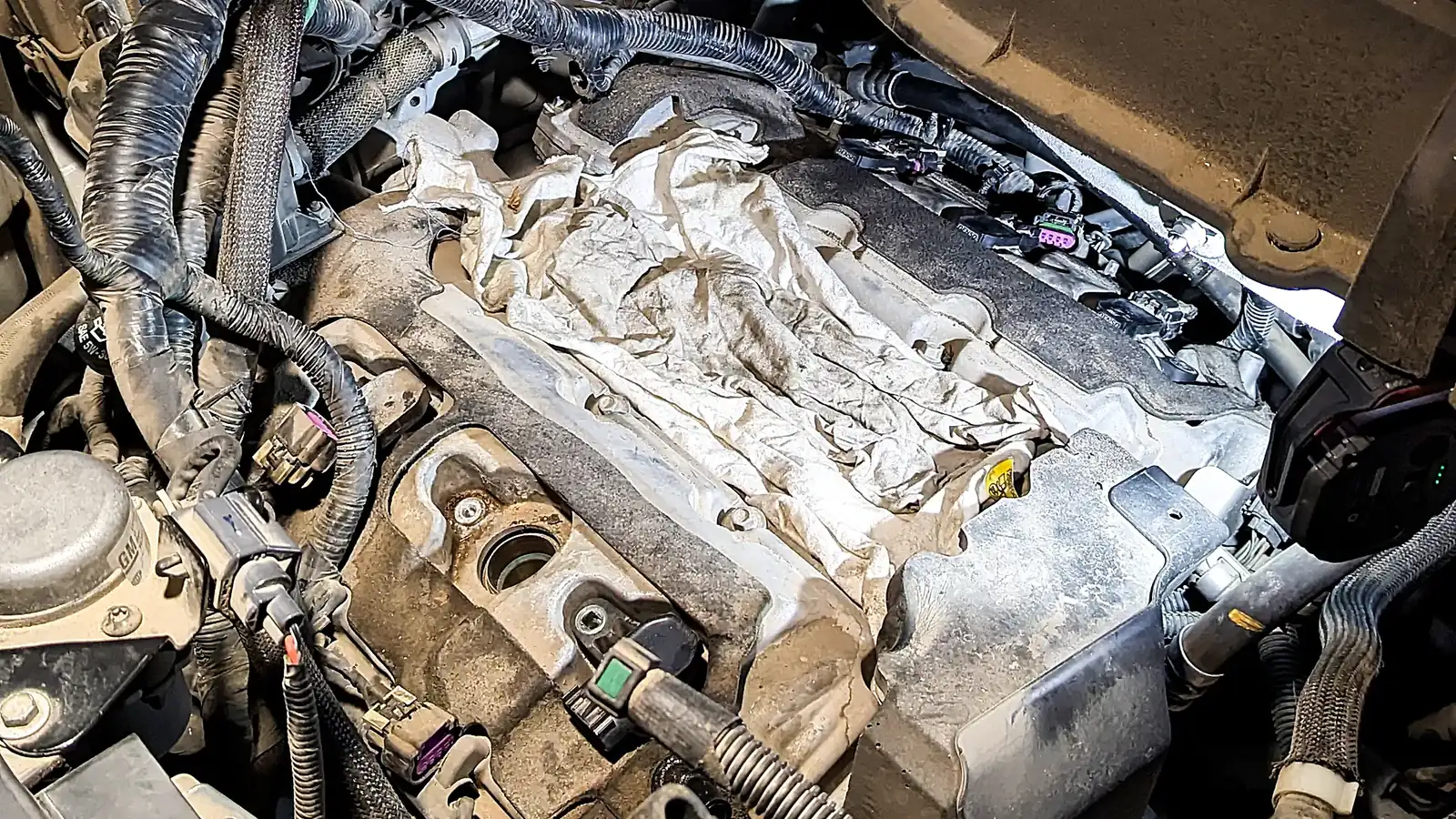 Engine bay opened up with the intake removed during an on-site engine repair