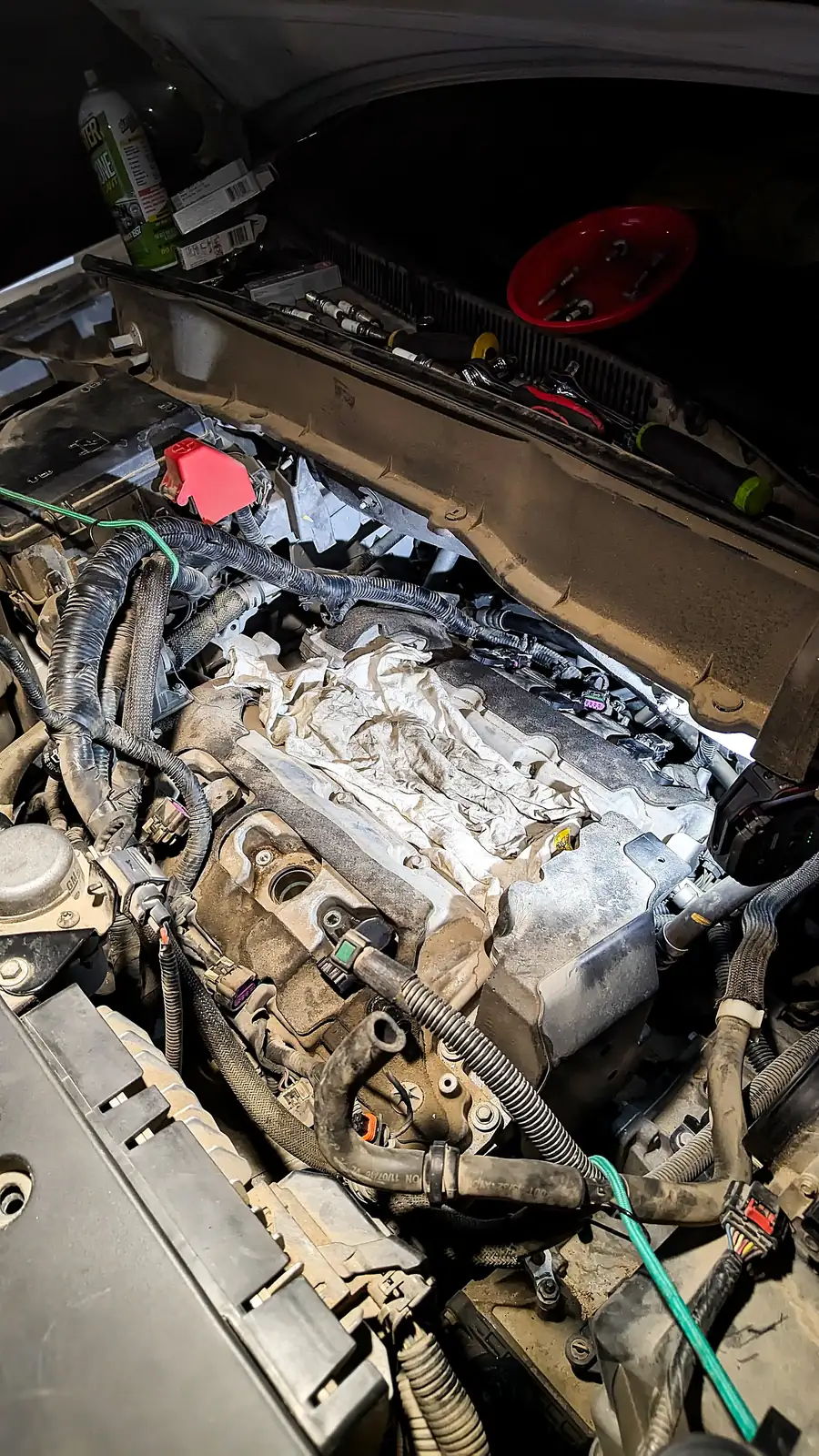 Engine bay opened up with the intake removed during an on-site engine repair